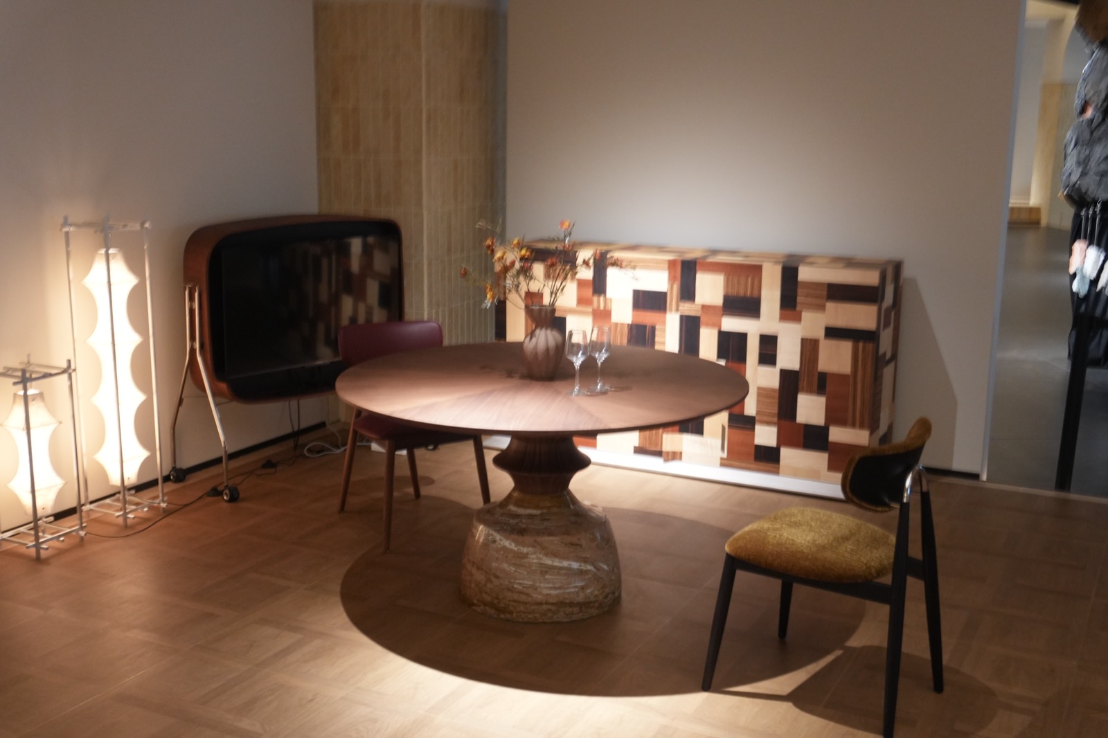 Geometric wood cabinetry displayed with a round dining table