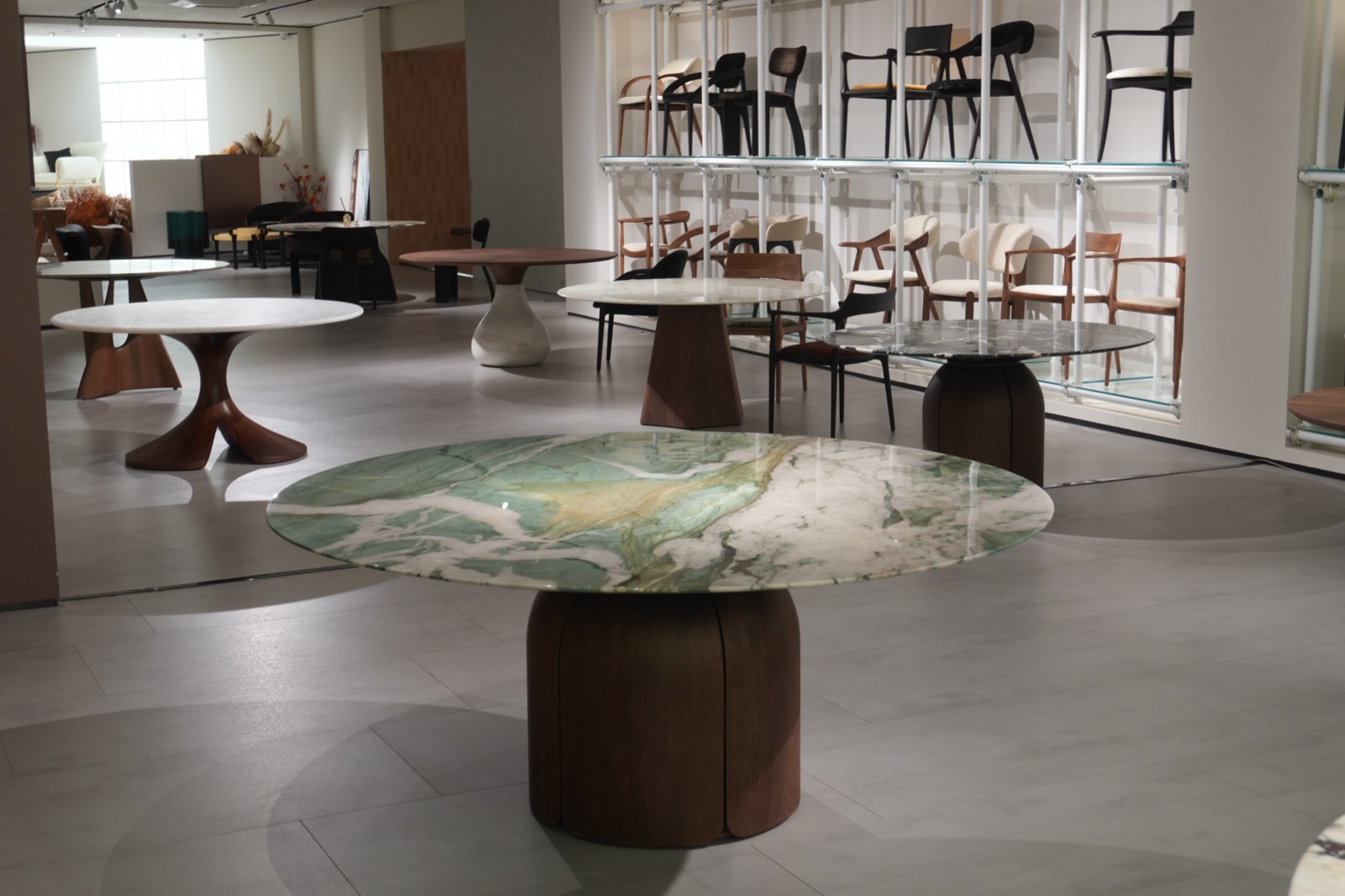 Natural stone dining tables with sculptural wooden bases